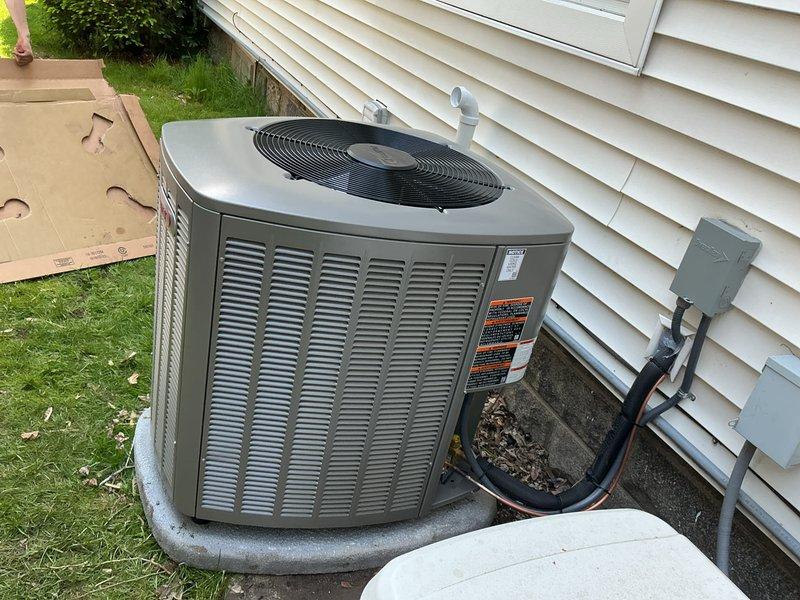 Successfully completed installation of a 3-ton air conditioning system with evaporator coil at residential property. The outdoor condenser unit was positioned in the rear yard on a concrete pad with proper clearances, connected to weatherproof electrical disconnect box, and refrigerant lines were insulated and secured along the foundation. The indoor evaporator coil was installed in the basement mechanical room and integrated with the existing furnace system. All refrigerant lines were properly connected, system was charged to manufacturer specifications, electrical connections were completed per code, and unit was tested for proper operation and airflow.