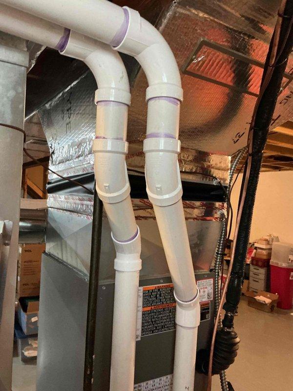 Responded to service call for furnace with peeling duct tape at plenum connection. Inspected HVAC system in basement and found deteriorating foil tape seal where supply plenum meets furnace cabinet. Removed old failing tape, cleaned surfaces, and resealed duct connection with proper HVAC foil tape to restore air-tight seal and prevent conditioned air loss. Verified all PVC condensate drain lines and venting connections secure. System operating normally with proper airflow restored at plenum junction.
