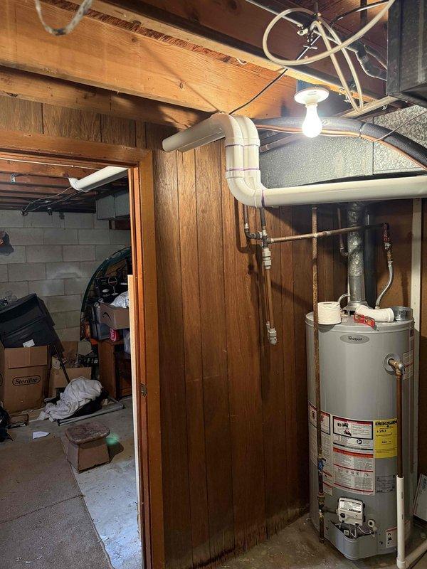 Completed full HVAC system installation including a 70,000 BTU furnace and 2-ton air conditioning unit with rear discharge configuration. Installed condensate drainage line with PVC piping routed to building exterior, reconnected all existing ductwork and utilities, and verified proper system operation. All mechanical permits obtained and installation completed per code requirements in basement utility area.
