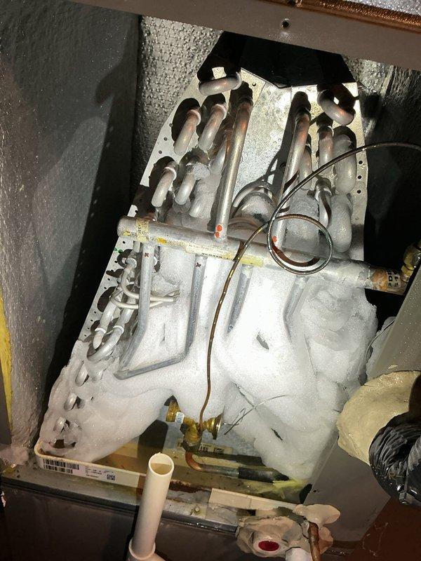 Responded to no cooling complaint on central air conditioning system less than 5 years old. Upon arrival, found evaporator coil completely frozen with heavy ice buildup, confirming customer report of unit running continuously without adequate cooling. Documented extensive frost accumulation on coil assembly and surrounding components. Identified restricted airflow as primary cause of coil icing, likely due to dirty air filter or reduced system airflow. Recommended system shutdown to allow complete ice melt, filter replacement, and thorough airflow assessment before restart to prevent recurrence and potential compressor damage.