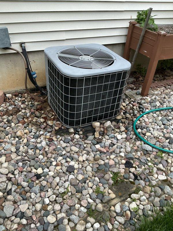 Completed routine annual tune-up on 20-year-old residential air conditioning system. Performed comprehensive inspection of outdoor condenser unit, verified electrical connections, and measured system capacitance reading of 0.27 using digital multimeter. All components operating within normal parameters with no issues identified during inspection. System confirmed ready for cooling season operation.