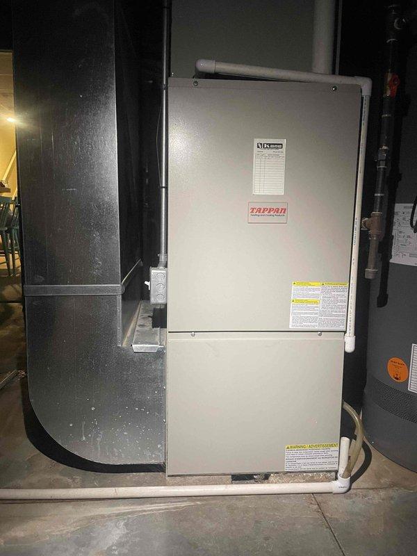 Conducted comprehensive assessment of existing 20-year-old furnace and air conditioning system for full replacement estimate. Inspected current Tappan air handler unit and associated HVAC equipment in mechanical space, documented existing system configuration including ductwork routing through attic space, and photographed equipment specifications and installation conditions. Provided replacement options for complete heating and cooling system upgrade based on current equipment age and customer's request for expedited installation timeline.