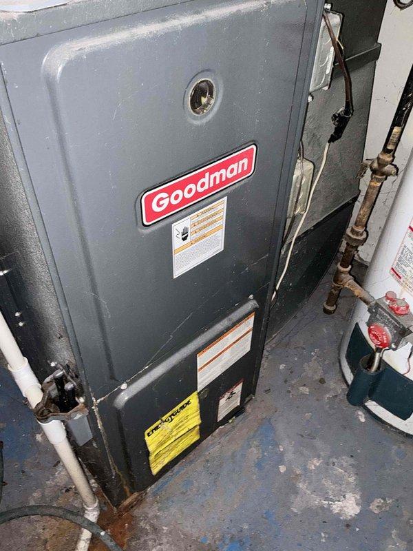 Conducted comprehensive assessment of existing 15-year-old Goodman HVAC system including air conditioning unit and furnace located in basement mechanical room. Evaluated current equipment condition, noting aged copper refrigerant lines with weathered brass fittings, existing PVC condensate drainage system, and overall cabinet wear consistent with equipment age. Documented system specifications and existing installation configuration to provide detailed estimate for complete system replacement of both heating and cooling components.