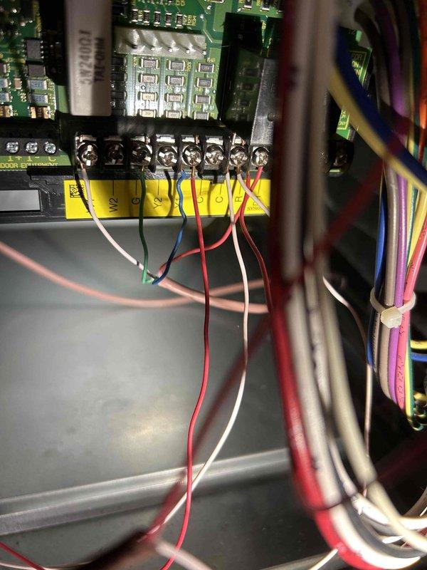 Responded to no cooling complaint on five-year-old air conditioning system. Upon arrival, inspected indoor unit control board and thermostat wiring connections at terminal strip. Verified proper wire terminations at Y1, Y2, R, C, and W2 terminals, checked for loose connections or damaged wiring. Documented control board configuration and wiring setup with photos for service records. System evaluated and appropriate recommendations provided to restore cooling operation.