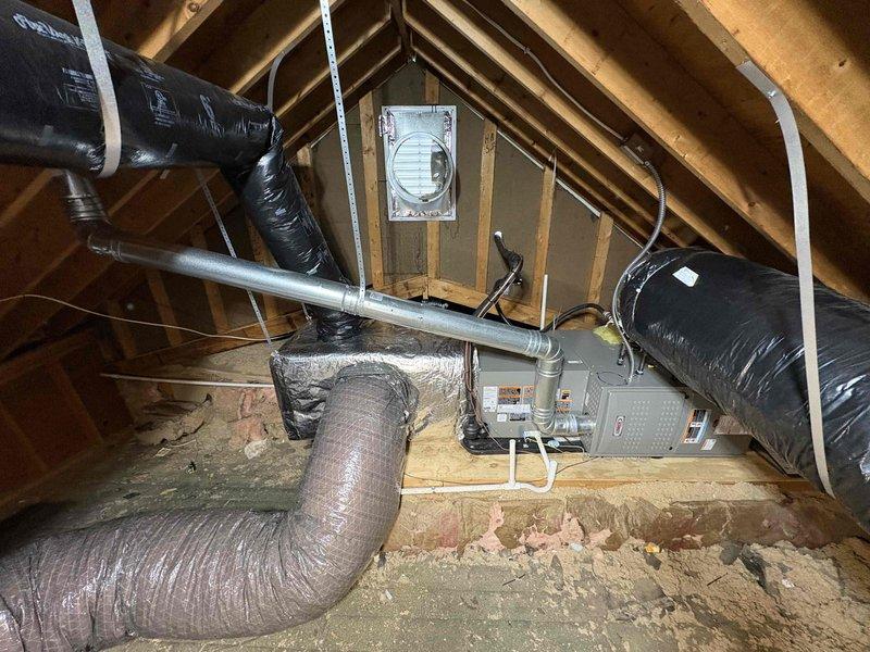 Completed full HVAC system installation including a 70,000 BTU furnace and 2.5-ton air conditioning unit with right-side configuration. Installed new condensing unit on exterior pad with properly insulated refrigerant lines routed and secured along exterior wall. Positioned and connected furnace in attic space with complete ductwork installation including flexible insulated ducts and rigid metal supply trunk lines secured to structural beams. Reconnected all electrical connections and verified proper system operation. Mechanical and electrical permits obtained prior to installation.
