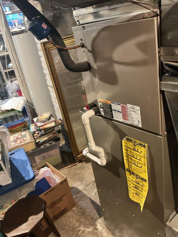 Completed annual comprehensive maintenance on residential HVAC system. Inspected furnace unit, verified proper operation of all components, and replaced air filter with new pleated media filter. Documented system condition with photos showing furnace installation, ductwork connections, PVC condensate drainage, and filter replacement to maintain optimal system performance and air quality.