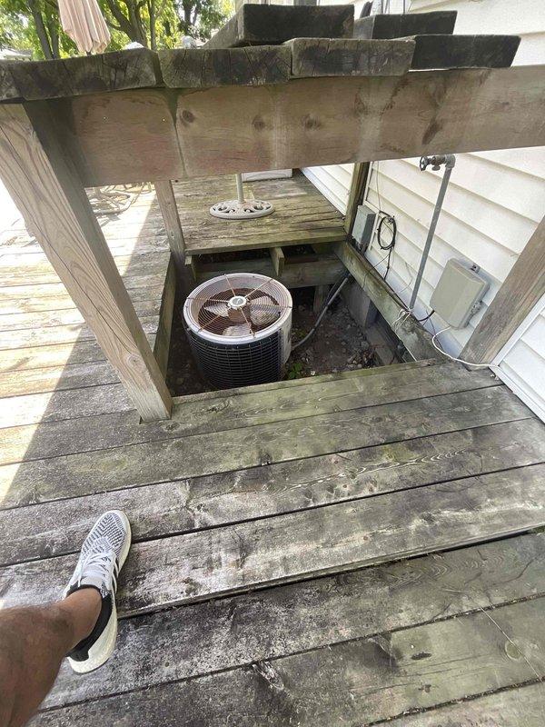 Conducted comprehensive on-site assessment for complete HVAC system replacement at residential property with 20+ year-old non-operational equipment. Evaluated existing natural gas furnace located in basement and air conditioning condenser unit installed in recessed compartment beneath exterior deck structure. Documented current equipment configuration, including unique deck-mounted AC installation with built-in access hatch, electrical connections, and refrigerant line routing. Provided detailed replacement estimate for new furnace and air conditioning system to restore climate control functionality.