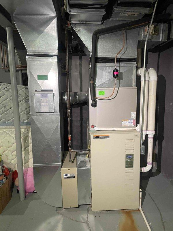 Conducted comprehensive assessment of existing 9-year-old Carrier 4-ton air conditioning system located in basement with upstairs cooling deficiencies. Unit operates continuously but fails to adequately cool upper level, indicating undersized equipment for home's cooling load requirements. Performed detailed measurements of existing ductwork and equipment clearances in attic installation area. Evaluated natural gas furnace integration and current HVAC infrastructure including ductwork configuration, refrigerant line routing, and ventilation components. Documented equipment specifications, spatial constraints, and existing system layout to prepare replacement estimate for properly sized cooling system that will meet home's calculated load requirements and resolve inadequate upstairs temperature control issues.