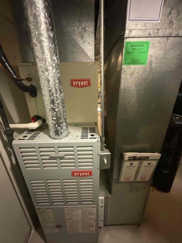 Provided estimate for replacement of 28-year-old non-functional HVAC system located in basement, including both furnace and air conditioning unit. Customer primarily interested in air conditioning replacement but requested information on buy-one-get-one promotion for complete system upgrade. Documented existing Bryant furnace installation with connected ductwork, air handler, and filter cabinet for accurate equipment sizing and replacement specifications.