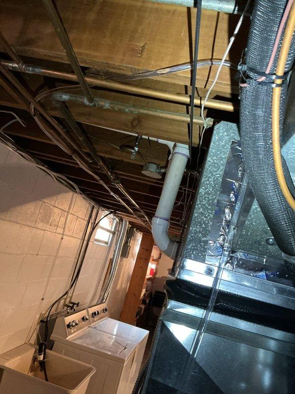 Responded to service call for basement-located air conditioning system. Upon inspection, found condensate pump filled with mildew and biological growth, indicating drainage system contamination. Assessed pump condition and determined replacement necessary due to extent of mildew accumulation affecting proper condensate removal. Documented equipment location and current system configuration including ductwork and drainage components. Recommended condensate pump replacement to restore proper system drainage and prevent potential water damage or system shutdown.