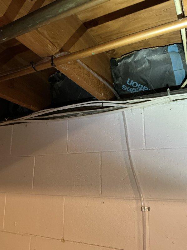 Responded to service call for basement-located air conditioning system. Upon inspection, found condensate pump filled with mildew and biological growth, indicating drainage system contamination. Assessed pump condition and determined replacement necessary due to extent of mildew accumulation affecting proper condensate removal. Documented equipment location and current system configuration including ductwork and drainage components. Recommended condensate pump replacement to restore proper system drainage and prevent potential water damage or system shutdown.