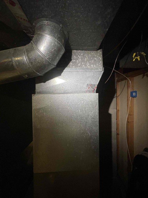 Conducted comprehensive assessment of basement-located HVAC system for replacement estimate including 30-year-old natural gas furnace and non-operational air conditioning unit of unknown age. Documented existing equipment condition, noting significant moisture damage and water staining on concrete floor surrounding units, and evaluated mechanical components, ductwork connections, and installation environment to provide accurate replacement specifications for complete furnace and AC system.