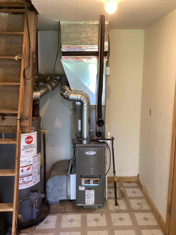 Completed full HVAC system installation including a 45,000 BTU furnace and 1.5 ton air conditioning unit. Installed furnace in basement utility area with proper ventilation ducting and connections, positioned on left side configuration with reconnection to existing infrastructure. Mounted outdoor condenser unit on exterior grade with refrigerant lines and electrical conduit run along siding to disconnect box. All permits secured prior to installation, system installed per mechanical specifications and code requirements.
