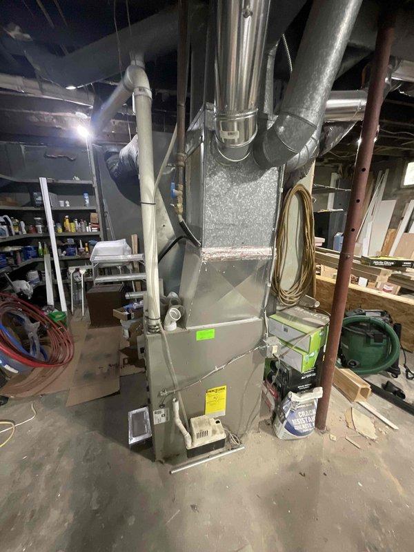 Conducted on-site assessment for furnace replacement estimate in residential basement. Evaluated existing 10-year-old vertical furnace system with current ductwork configuration, electrical service panel capacity, and installation requirements for new equipment to facilitate routine replacement with no immediate system failures present.