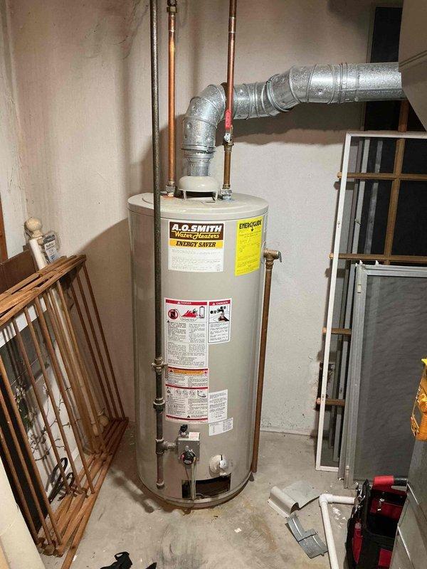Responded to service call for water heater replacement quote. Upon arrival, inspected existing A.O. Smith tank-type water heater located in basement utility area. Unit was confirmed to be over 8 years old and customer requested pricing for new water heater installation. Documented current installation configuration including copper supply lines, venting system with flexible aluminum ductwork, and shutoff valve locations. Photographed existing equipment and plumbing connections to provide accurate replacement quote for comparable unit.