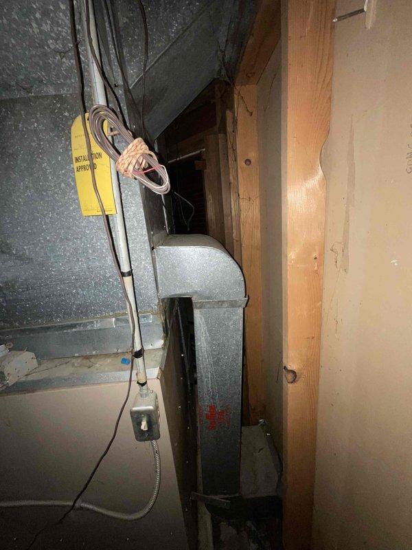 Conducted on-site assessment for HVAC system replacement estimate as part of furnace and air conditioner upgrade inquiry. Evaluated existing air conditioning equipment and ductwork configuration in mechanical space, documenting current system installation including air handler unit and associated ductwork connections. Photographed equipment layout and existing infrastructure to support replacement proposal development for complete heating and cooling system upgrade.