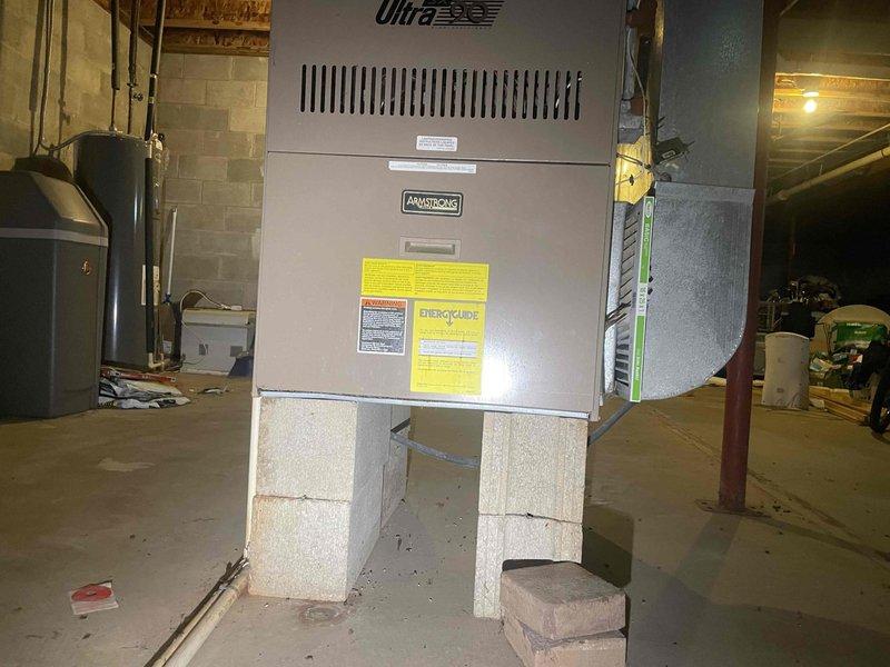 Conducted comprehensive assessment of existing 16-year-old Armstrong Ultra furnace system in basement installation for full HVAC system replacement estimate. Customer requested quote for complete furnace replacement and new air conditioning installation, with project timeline within the next couple weeks. Evaluated current equipment condition, ductwork configuration, electrical service capacity, and installation parameters including existing concrete block support structure and utility room layout. Documented existing system specifications, measured space requirements for new equipment installation, assessed ventilation and condensate drainage routing, and determined compatibility requirements for integrated heating and cooling system. Provided detailed replacement options and specifications for modern high-efficiency furnace and air conditioning system to meet customer's comfort needs.