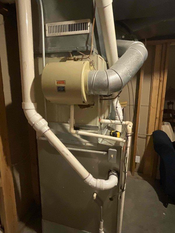 Conducted on-site assessment for replacement estimate of 15+ year old natural gas furnace and air conditioning system located in basement. Evaluated existing HVAC installation including furnace with integrated humidifier, PVC condensate drainage lines, ductwork configuration, and exterior electrical service connections to provide comprehensive equipment replacement recommendations for Air Care Member.