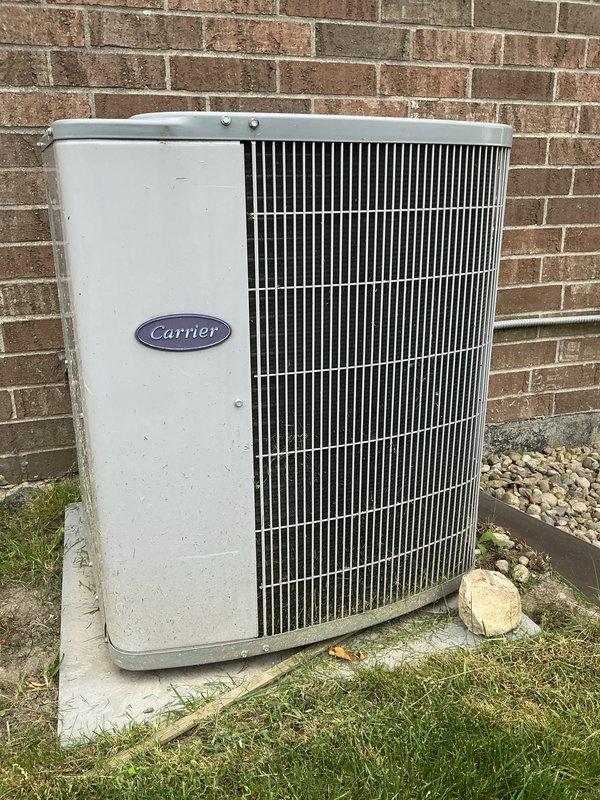 Completed comprehensive air conditioning tune-up on 11-year-old Carrier condensing unit. Performed full system inspection including condenser coil cleaning, refrigerant level verification, electrical connection testing, capacitor evaluation, and airflow assessment. Unit operating within manufacturer specifications with all components functioning properly.