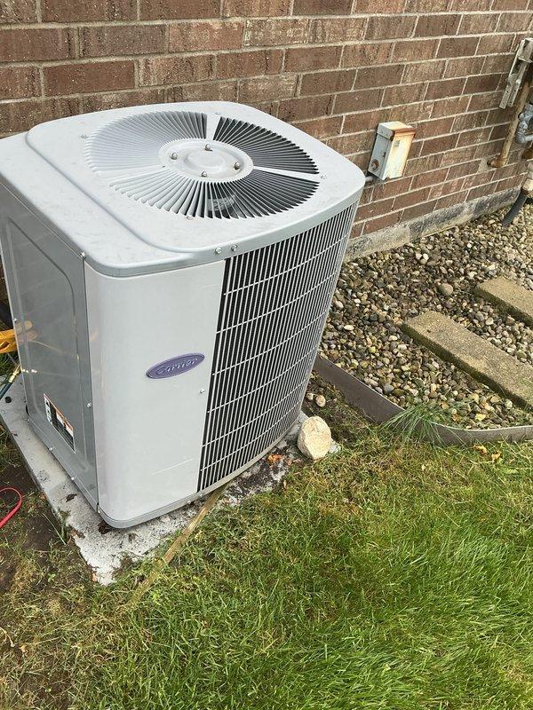 Completed comprehensive air conditioning tune-up on 11-year-old Carrier condensing unit. Performed full system inspection including condenser coil cleaning, refrigerant level verification, electrical connection testing, capacitor evaluation, and airflow assessment. Unit operating within manufacturer specifications with all components functioning properly.