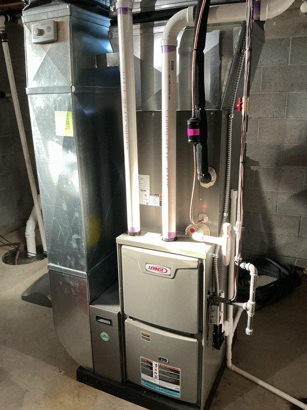 Completed annual cooling maintenance on residential HVAC system consisting of Lennox furnace and air handler unit located in basement. Performed comprehensive inspection of evaporator coil, condensate drainage system including PVC drain lines and trap, heat exchanger components, and all refrigerant lines. Verified proper operation of both units, checked electrical connections, and documented system condition with photographic records showing equipment in satisfactory working order with normal wear patterns on coil fins.