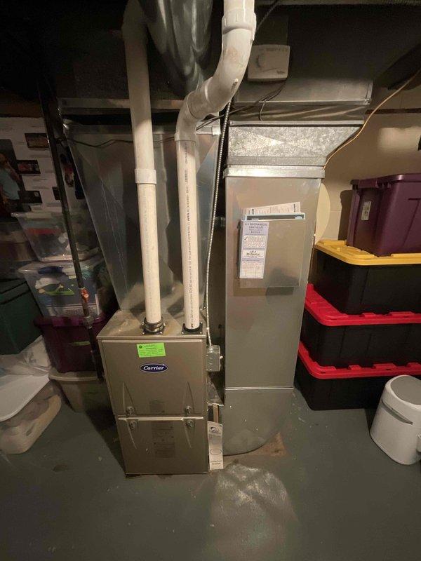 Completed on-site assessment for whole-house air conditioning system installation at residence with no existing AC equipment. Evaluated basement mechanical room containing Carrier furnace, water heater, and existing ductwork infrastructure to determine optimal placement and integration requirements for new cooling system. Provided comprehensive estimate for complete AC system installation including outdoor condensing unit, indoor evaporator coil, refrigerant lines, electrical connections, and necessary modifications to existing ductwork for whole-house cooling distribution.