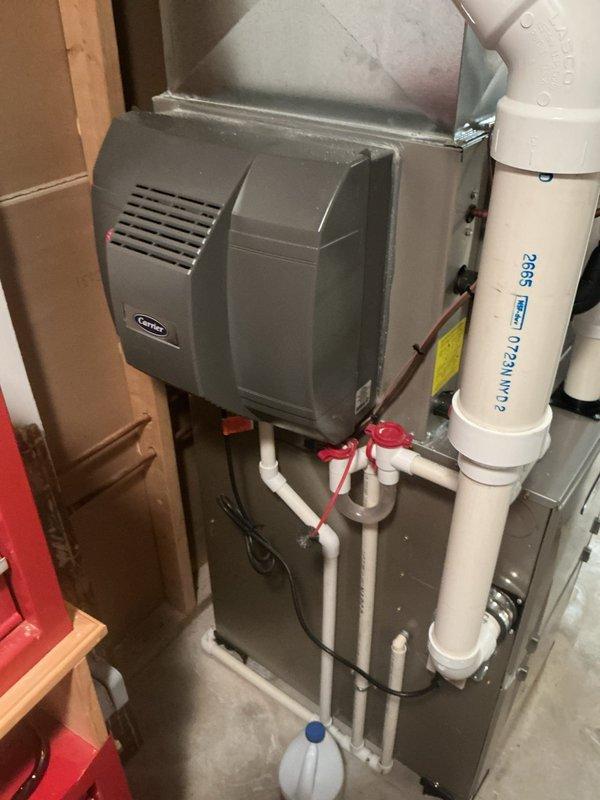 Completed annual cooling maintenance on residential HVAC system including inspection of Aprilaire humidifier unit mounted on supply ductwork and evaluation of air handler model H10HSCLFLE416-A24. Observed normal condensation on refrigerant lines and equipment surfaces indicating proper system operation in cooling mode, verified all components secured and functioning within normal parameters.