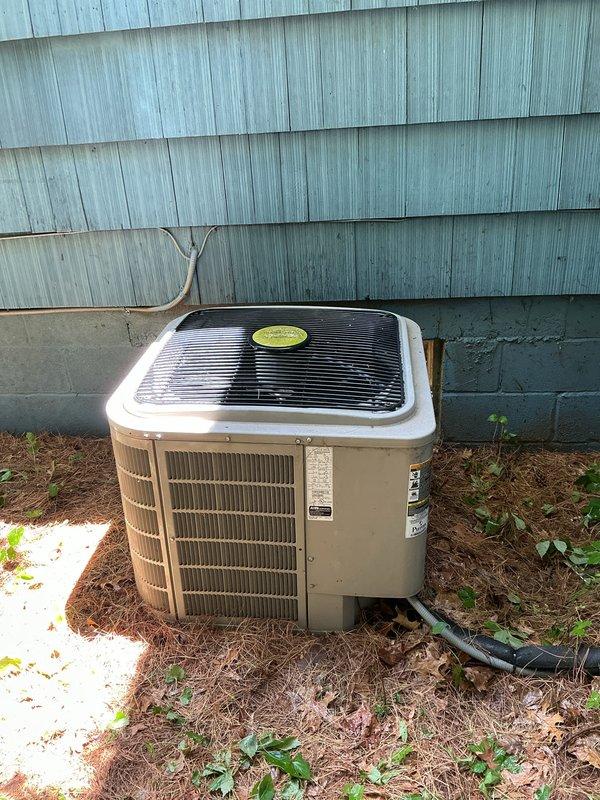 Completed annual cooling maintenance on residential outdoor condenser unit. Performed comprehensive system inspection, cleaned condenser coils, removed debris and cobwebs from top grille and surrounding area, verified refrigerant lines and electrical connections, and confirmed unit operational status for upcoming cooling season.