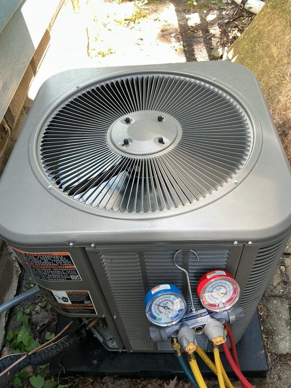 Performed routine Air Care Cooling maintenance on residential outdoor condenser unit. Connected manifold gauge set to service ports to verify system pressures and refrigerant charge levels, confirming unit operating within normal parameters. Inspected condenser coil, fan assembly, and electrical components with no issues identified during this scheduled preventive maintenance visit.