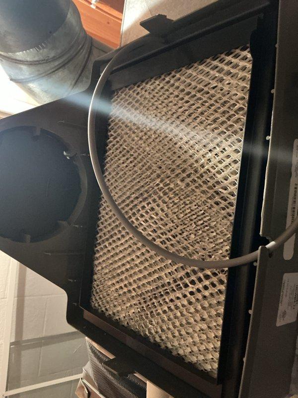 Completed annual cooling maintenance on Lennox HVAC system. Inspected air handler unit and furnace, documenting heavily soiled air filter with significant dust and debris accumulation across entire surface. Filter displayed darkened discoloration and concentrated buildup requiring replacement. Verified proper operation of system components, checked condensate drainage lines and PVC venting connections for proper function and secure installation. System operational upon completion of maintenance service.