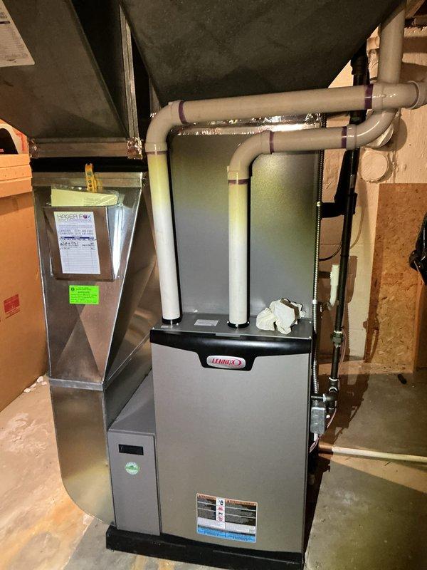 Completed annual cooling maintenance on Lennox HVAC system. Inspected air handler unit and furnace, documenting heavily soiled air filter with significant dust and debris accumulation across entire surface. Filter displayed darkened discoloration and concentrated buildup requiring replacement. Verified proper operation of system components, checked condensate drainage lines and PVC venting connections for proper function and secure installation. System operational upon completion of maintenance service.