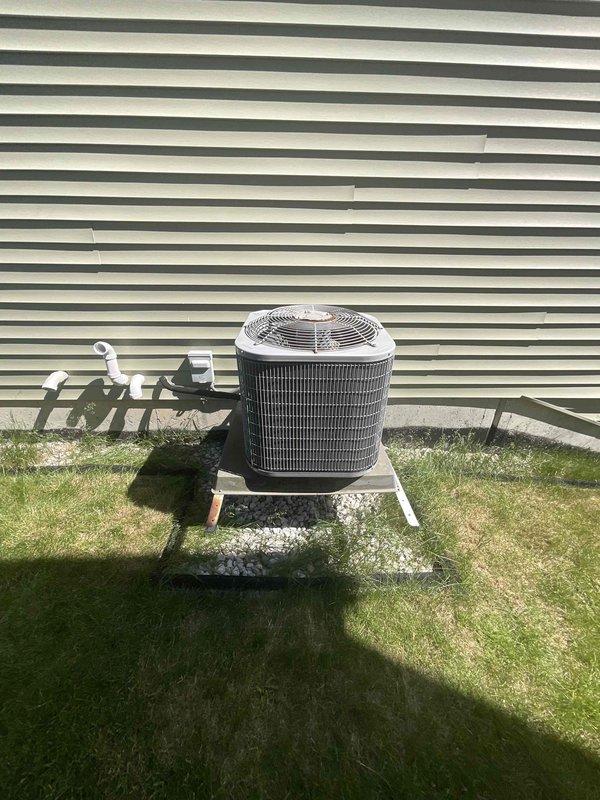 Conducted site evaluation and provided replacement estimate for an 11-year-old residential air conditioning system. Inspected existing outdoor condenser unit mounted on concrete pad with gravel surround, documented refrigerant line connections and electrical conduit routing. Reviewed electrical panel configuration noting dual AC circuit breakers and verified adequate electrical capacity for potential system upgrade. Photographed current installation including equipment placement, piping configuration, and electrical service to provide accurate replacement quote for new AC unit.