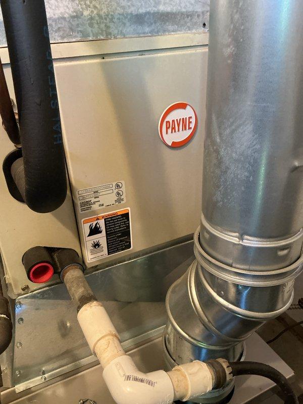 Performed comprehensive AC tune-up on 20-year-old Payne wall unit located in utility closet. Inspected compressor, evaporator coils, blower assembly, refrigerant lines, and electrical connections; all components found operating within normal parameters. Cleaned condenser coils, verified proper refrigerant charge, tested capacitor and contactor function, checked condensate drainage system, and confirmed system cooling performance with no deficiencies noted at time of service.