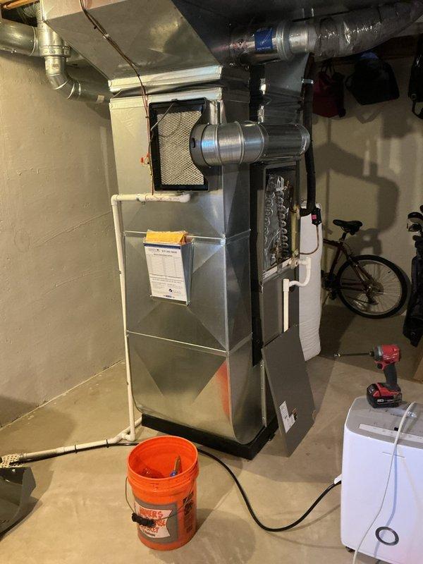 Completed comprehensive 5-year ComfortGuard Maintenance inspection on residential furnace system located in basement utility area. Performed thorough examination of gas valve assembly, verified proper wire connections and harness integrity across all electrical components. Inspected blower motor assembly, flexible gas tubing, and PVC condensate drainage system for proper operation and secure mounting. Examined ductwork including flexible insulated ducting and main trunk lines for integrity and proper sealing. Verified mesh filter condition and accessibility. All mechanical components, safety labels, and warning indicators confirmed present and legible. System operating within normal parameters with standard equipment wear consistent with age and usage.