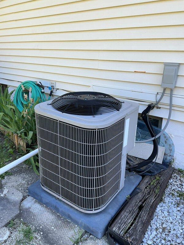 Completed comprehensive tune-up on 10-year-old residential air conditioning system with outdoor condenser unit installed on composite pad against exterior foundation. Performed standard preventive maintenance procedures including coil inspection, electrical connection verification, and refrigerant system evaluation to ensure optimal cooling performance for the upcoming season.