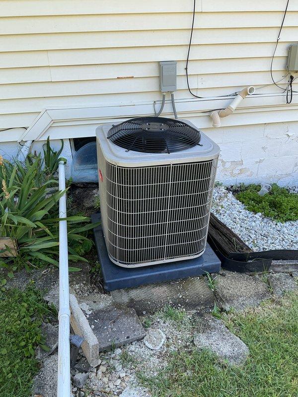 Completed comprehensive tune-up on 10-year-old residential air conditioning system with outdoor condenser unit installed on composite pad against exterior foundation. Performed standard preventive maintenance procedures including coil inspection, electrical connection verification, and refrigerant system evaluation to ensure optimal cooling performance for the upcoming season.