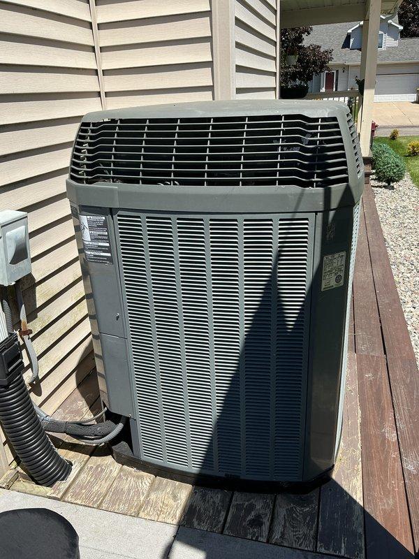Completed annual cooling maintenance on residential outdoor condensing unit. Performed comprehensive inspection of unit mounted on exterior deck platform, verified proper airflow through louvered panels, checked refrigerant lines and electrical connections, and documented system condition with photographs. Unit operating within normal parameters following routine preventative maintenance protocol.