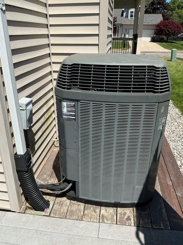 Completed annual cooling maintenance on residential outdoor condensing unit. Performed comprehensive inspection of unit mounted on exterior deck platform, verified proper airflow through louvered panels, checked refrigerant lines and electrical connections, and documented system condition with photographs. Unit operating within normal parameters following routine preventative maintenance protocol.