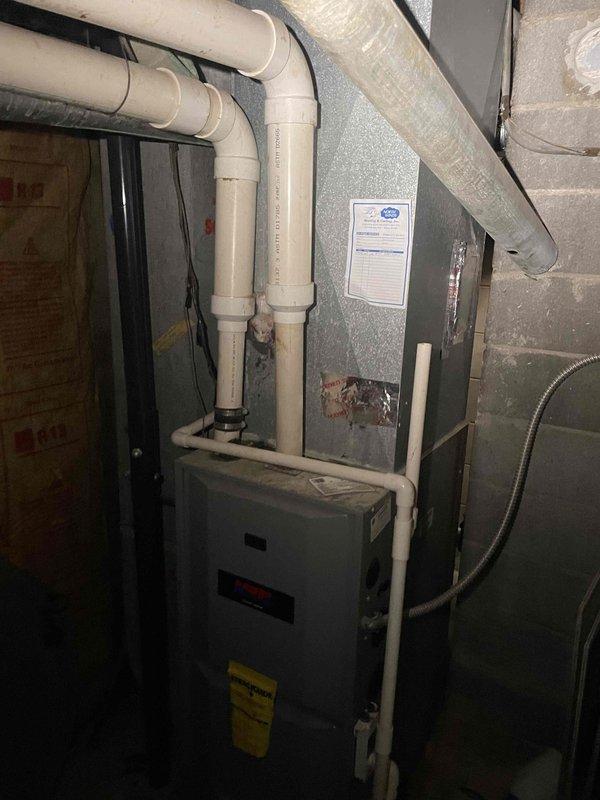 Conducted on-site assessment of existing 23-year-old air conditioning system for full replacement estimate. Evaluated current HVAC equipment configuration in basement utility area, including furnace unit, ductwork, and associated plumbing connections. Documented equipment specifications, installation layout, and mechanical room conditions through photographic documentation. Reviewed system age and discussed replacement options with homeowner, including equipment specifications and available financing programs for new air conditioning system installation.