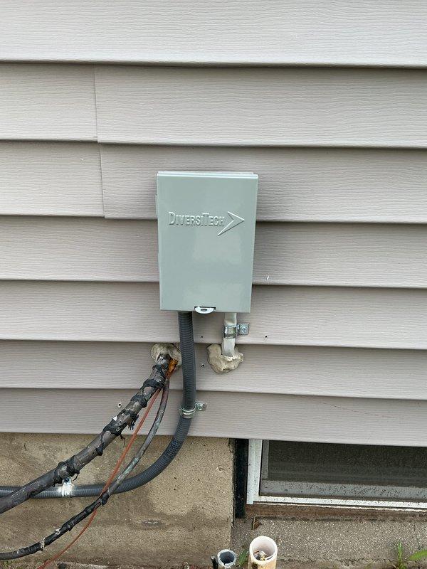 Installed new dedicated electrical circuit from main breaker panel to existing air conditioning unit. Ran appropriate gauge wiring through conduit from panel to exterior AC location. Mounted DiversiTech gray metal AC disconnect box on exterior wall per code requirements. Connected flexible conduit whip from disconnect to AC unit using proper weatherproofing techniques and securing methods. Added new circuit breaker in panel with appropriate amperage rating for AC load. Labeled new circuit in panel directory for future reference. All connections tested and verified operational.