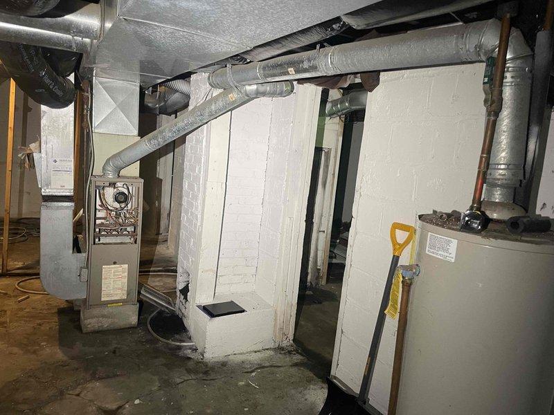Completed estimate consultation for furnace replacement at previously vacant residential property. Inspected existing HVAC system in basement utility area, documented aged furnace unit with no operational history for past year, assessed ductwork configuration including galvanized metal supply ducts and flexible return connections, and evaluated overall system layout for replacement planning. Provided replacement options and recommendations based on current equipment condition and home heating requirements.