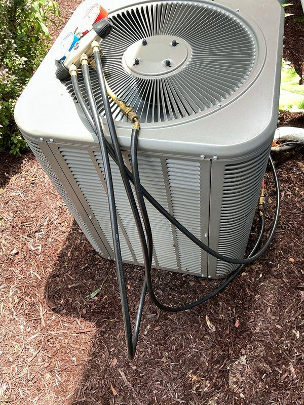 Completed annual cooling maintenance on residential air conditioning system. Performed comprehensive inspection of outdoor condenser unit, verified proper operation of compressor and fan motor, checked refrigerant pressures and temperatures using manifold gauges, and confirmed all electrical connections were secure. Replaced furnace filter and documented system condition with photographs showing unit in good working order with no visible defects or concerns.