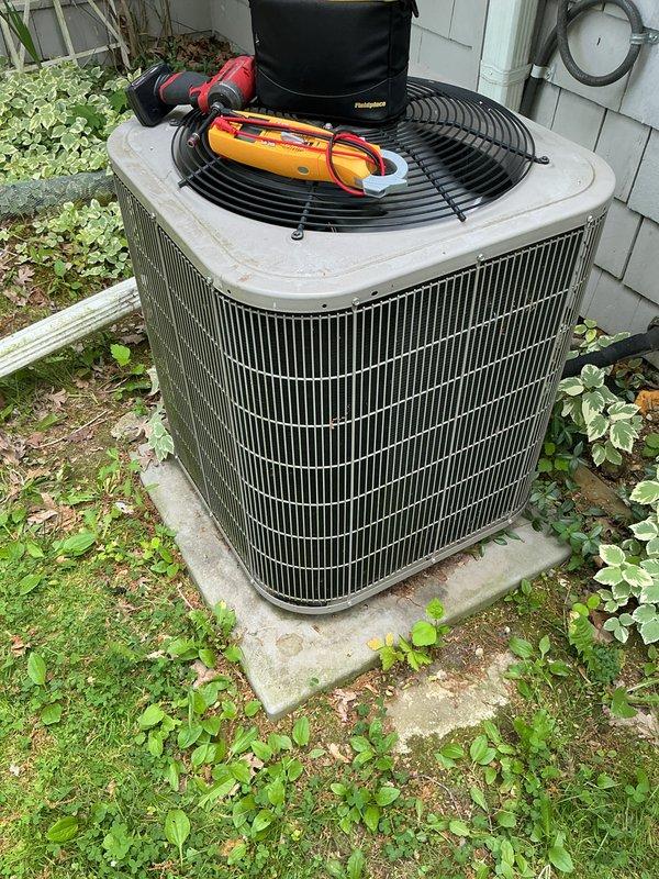 Completed annual cooling maintenance on residential outdoor condensing unit. Performed comprehensive system inspection, tested electrical components with digital multimeter recording capacitor reading of 2939 microfarads, cleaned condenser coil, and verified proper system operation. Unit found in good working condition with all components functioning within manufacturer specifications.
