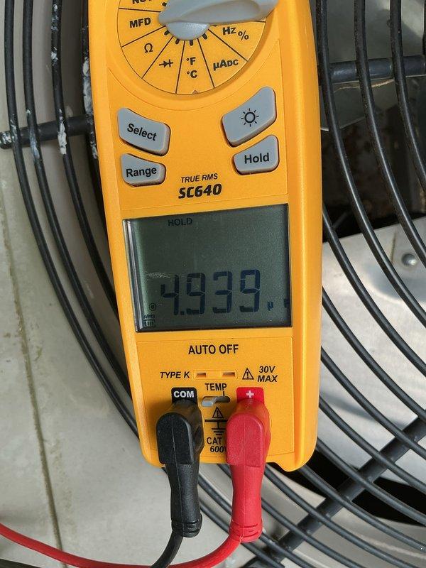 Completed annual cooling maintenance on residential outdoor condensing unit. Performed comprehensive system inspection, tested electrical components with digital multimeter recording capacitor reading of 2939 microfarads, cleaned condenser coil, and verified proper system operation. Unit found in good working condition with all components functioning within manufacturer specifications.