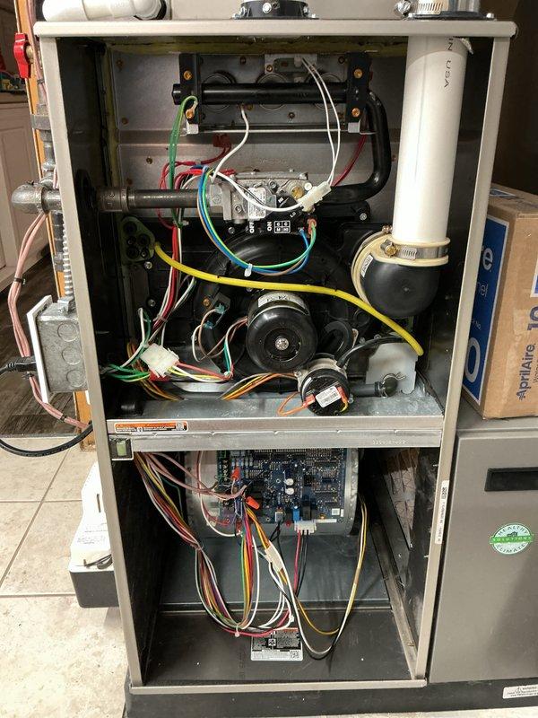Completed annual heating and cooling maintenance inspection on residential gas furnace system. Performed comprehensive evaluation of all internal components including gas valve assembly, heat exchanger, blower motor, control board, and electrical connections. Inspected PVC venting and condensate drain lines for proper installation and security. Verified all wire connections and control board functionality. Documented system condition through detailed photography of interior components with access panels removed. All components found operating within normal parameters with no immediate service needs identified.
