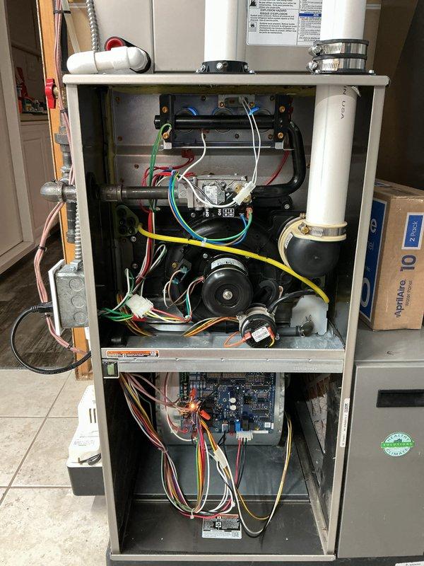 Completed annual heating and cooling maintenance inspection on residential gas furnace system. Performed comprehensive evaluation of all internal components including gas valve assembly, heat exchanger, blower motor, control board, and electrical connections. Inspected PVC venting and condensate drain lines for proper installation and security. Verified all wire connections and control board functionality. Documented system condition through detailed photography of interior components with access panels removed. All components found operating within normal parameters with no immediate service needs identified.