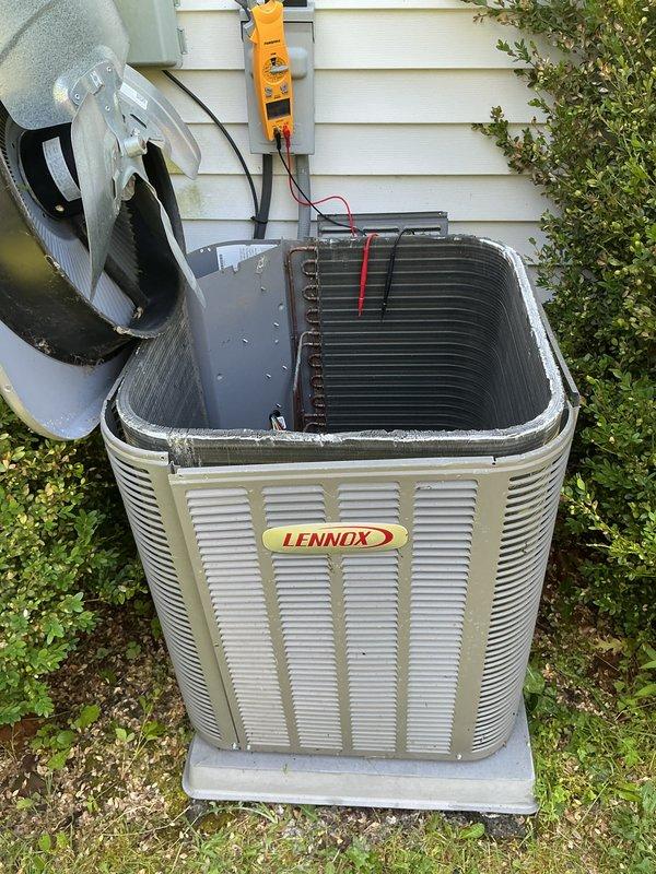 Completed annual cooling maintenance on Lennox air conditioning system. Performed electrical diagnostics using digital multimeter, recording amperage draw of 5.16A on compressor circuit. Removed condenser top panel to inspect internal components, checked condenser coil condition, and verified proper system operation. All measurements within normal operating parameters and unit functioning as designed.