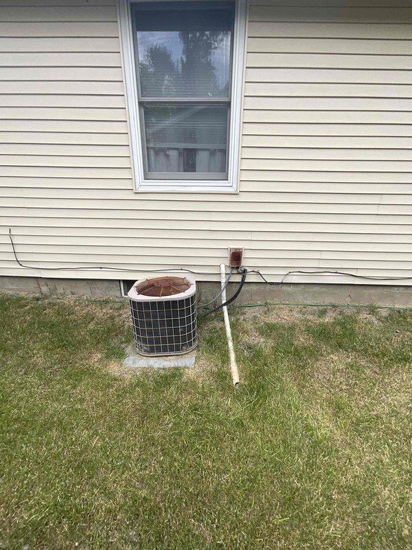 Provided estimate for complete HVAC system replacement including outdoor air conditioning condenser unit and basement-installed Gibson furnace. Existing equipment is over 15 years old and non-operational, with outdoor condenser showing significant rust deterioration on top surface. Assessment included evaluation of current ductwork configuration with flexible metallic ducting connecting floor-mounted furnace to overhead plenum system in basement utility area.