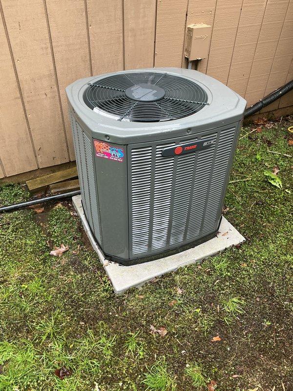 Completed annual cooling maintenance on Trane outdoor condensing unit. Inspected system components, photographed equipment condition, and identified need for air filter/evaporator pad replacement and thermostat service or replacement, with customer approval to proceed with recommended repairs.