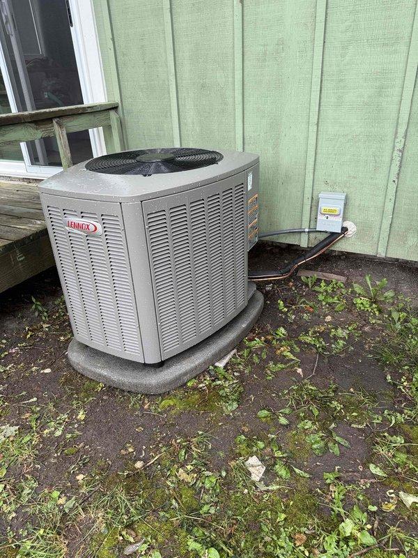 Completed full HVAC system installation including a 70,000 BTU gas furnace with humidifier and 2.5-ton Lennox air conditioning unit. The outdoor condensing unit was positioned on an existing concrete pad at the rear of the residence with refrigerant lines routed along the building exterior and electrical disconnect box mounted to exterior wall. All equipment was installed per manufacturer specifications, refrigerant lines were insulated and properly connected, and existing ductwork reconnection was completed to integrate the new furnace into the home's heating and cooling distribution system.